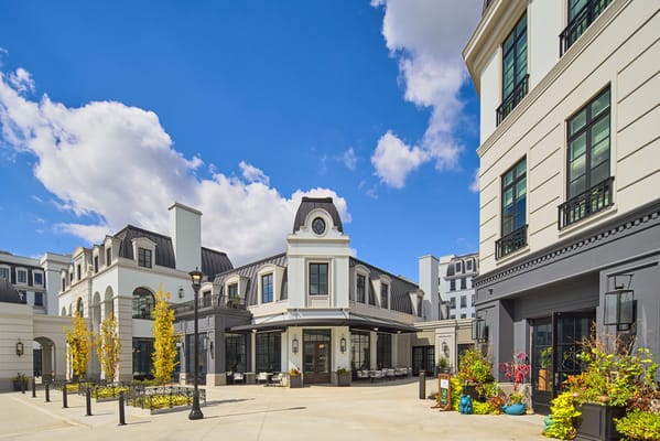 Exterior view of a senior living facility with landscaped outdoor space