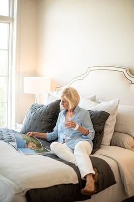 Resident enjoying a magazine in a cozy bedroom