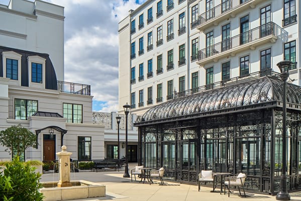 Outdoor sitting area with glass gazebo and fountain