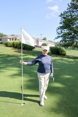 Senior resident enjoying a day of golf at the facility