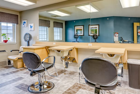 Salon area with styling chairs and mirrors