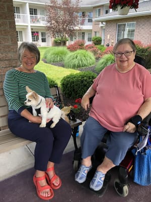 Residents enjoying time outdoors with a puppy