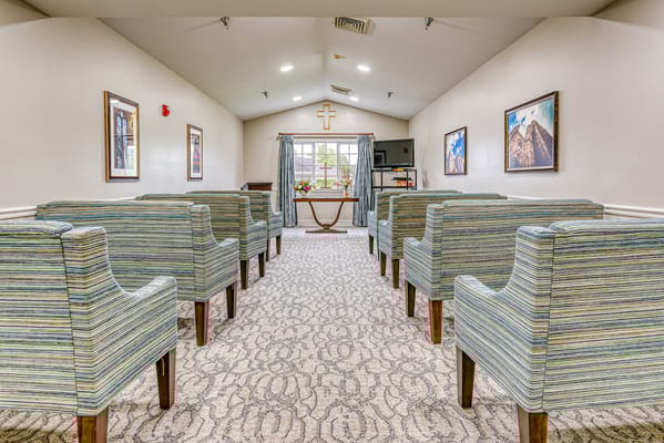 Bright common area with seating and large windows