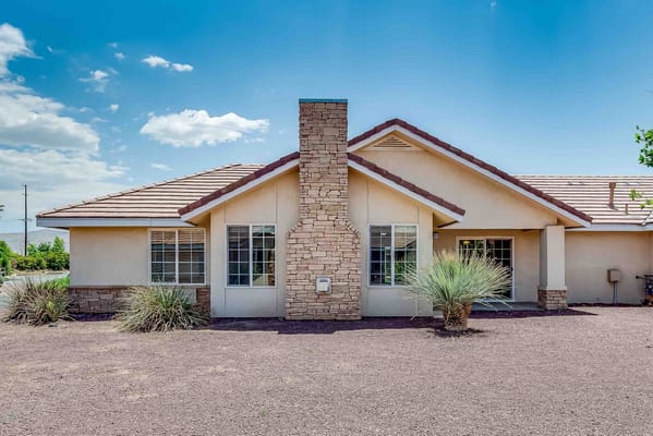 Exterior view of a senior living facility with landscaping