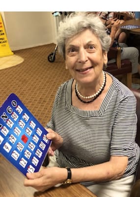 Resident enjoying a game of bingo in an activity room