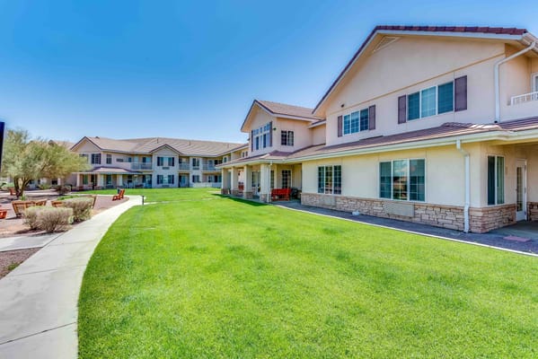 Exterior view of the assisted living facility with green lawns