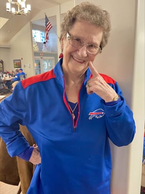 Resident smiling in a vibrant common area