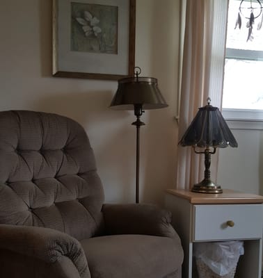 Cozy lounge chair with lamp in a private space