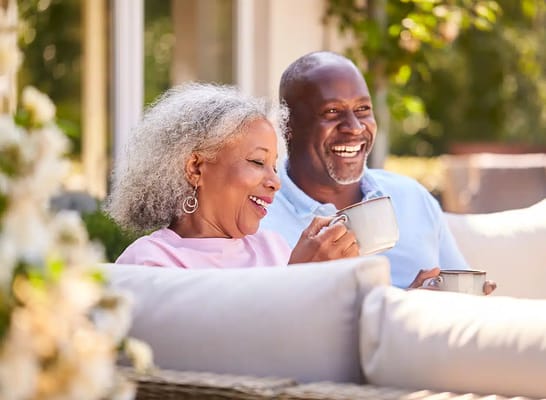 A couple enjoying tea on a sunny patio