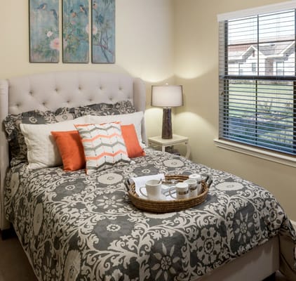 Cozy resident bedroom with decorative bedding