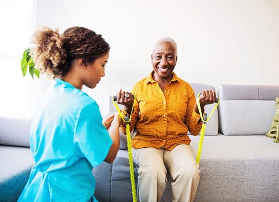 Therapist assisting a resident with exercises indoors