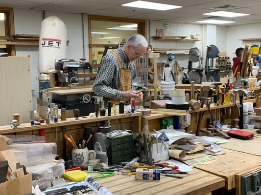 Resident working on a project in a woodworking shop