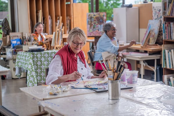 Residents participating in an art class in the activity room