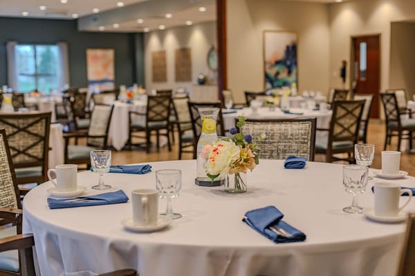 Dining room setup with tables and chairs