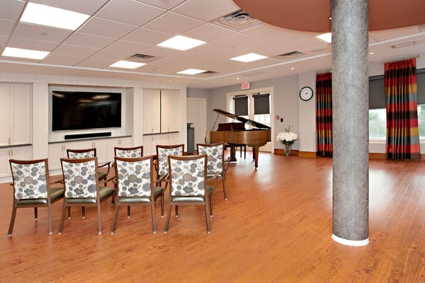 Interior view of a common area with seating and a piano