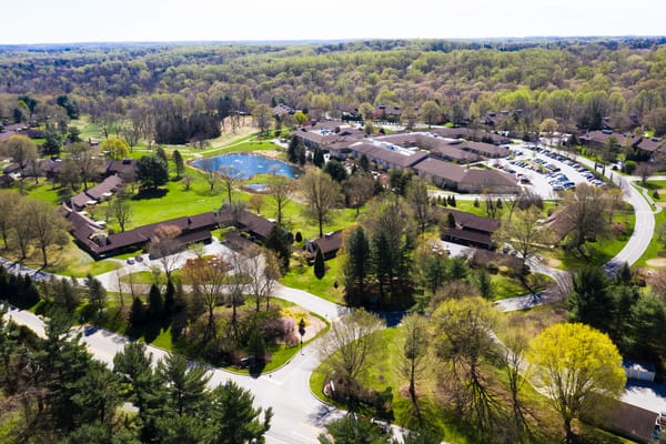 Aerial view of a senior living community with green spaces