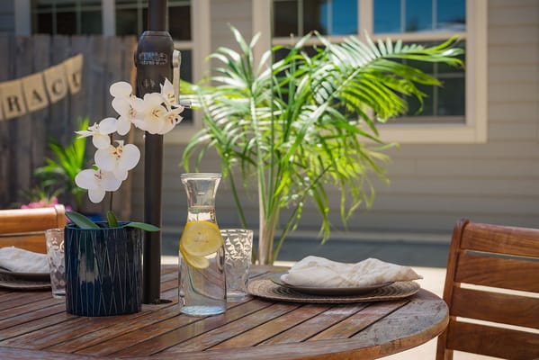 Outdoor dining table with flowers and water pitcher