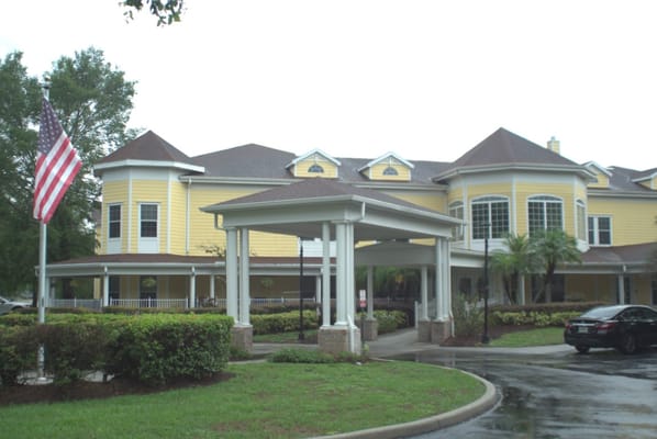 Exterior view of assisted living facility with yellow walls