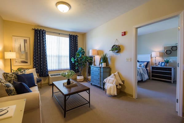 Cozy living room area with a bedroom visible