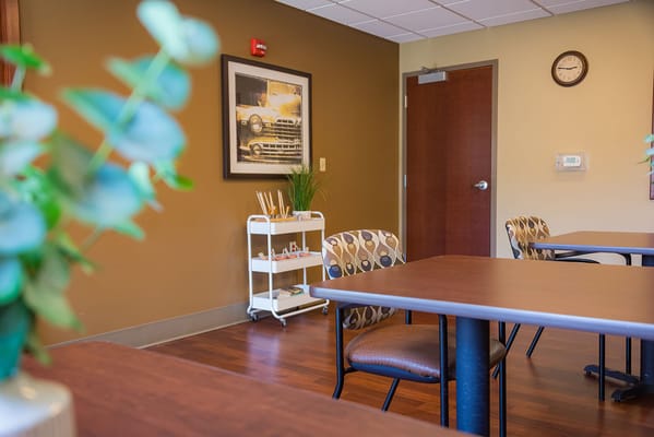 Common area within the senior living facility with tables and decor