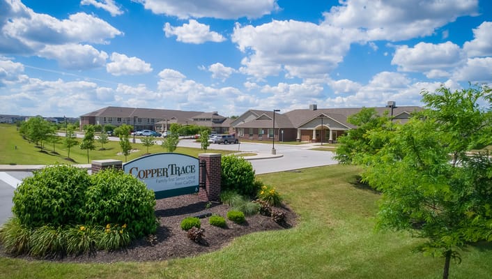Exterior view of Copper Trace Senior Living with signage
