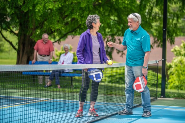 Residents enjoying a game of pickleball outdoors