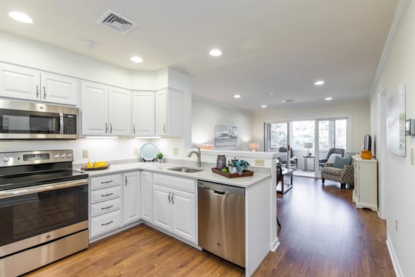 Bright, modern kitchen with a living area beyond