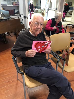 A resident holding a Valentine's card in a common area