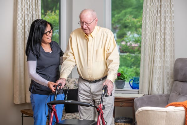 Staff assisting a resident with mobility