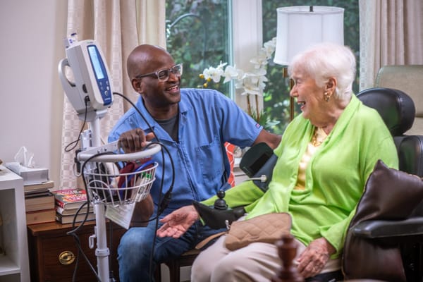 Healthcare professional interacting with a smiling resident