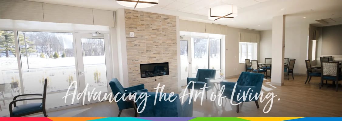 Bright common area with seating and a fireplace