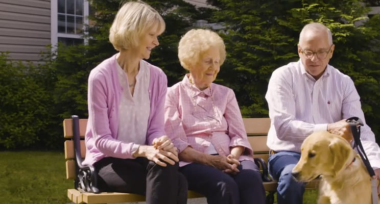 Residents enjoying outdoor time with a dog