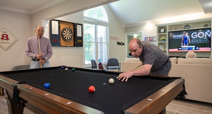 Residents playing billiards in a common area