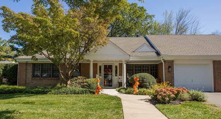Exterior view of a senior living facility with landscaped garden