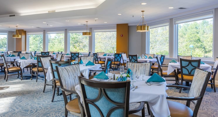 Bright dining room with tables set for meals