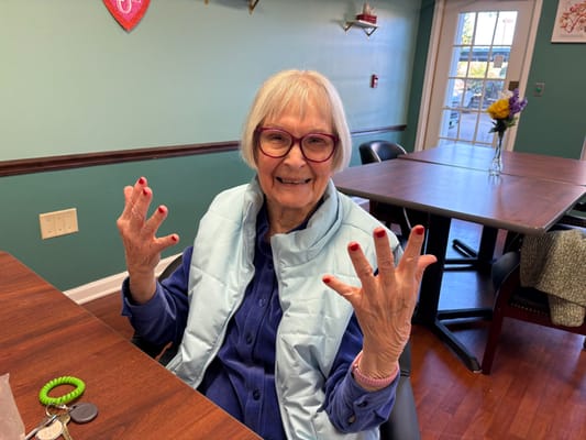 Resident showing off freshly painted nails in a common area