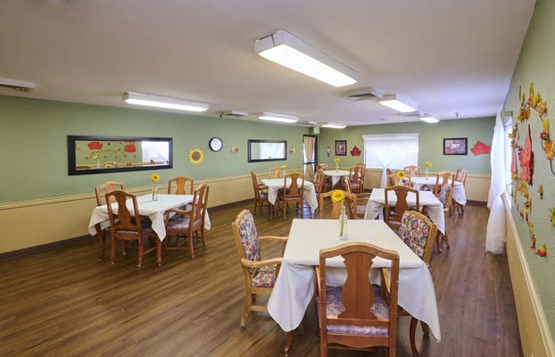Bright dining room with tables set for residents