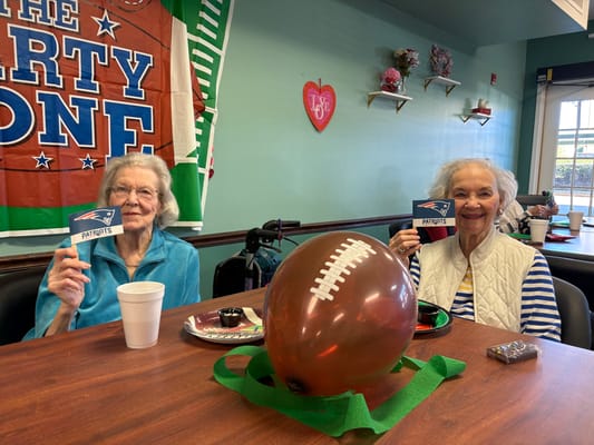 Two residents celebrating with sports-themed decorations