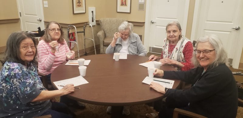 Residents engaged in an activity around a table