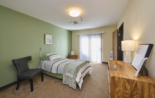 Cozy resident room with a bed and natural light