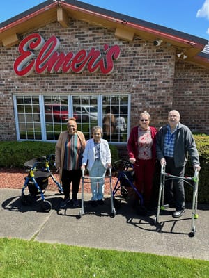 Residents and staff outside the facility entrance