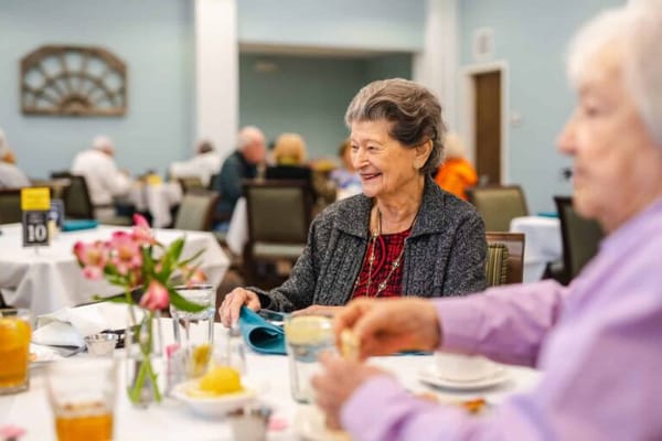 Residents enjoying a meal in the dining room
