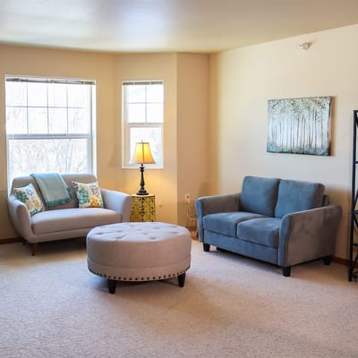 Cozy living room with a couch and ottoman