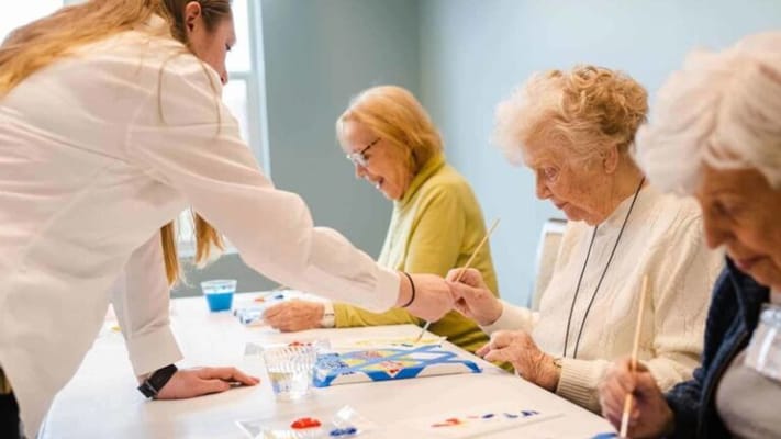 Residents participating in a painting activity.