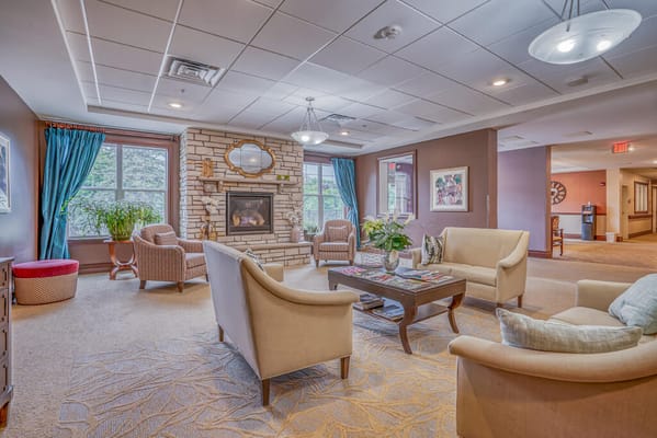 Bright common area with seating and a fireplace