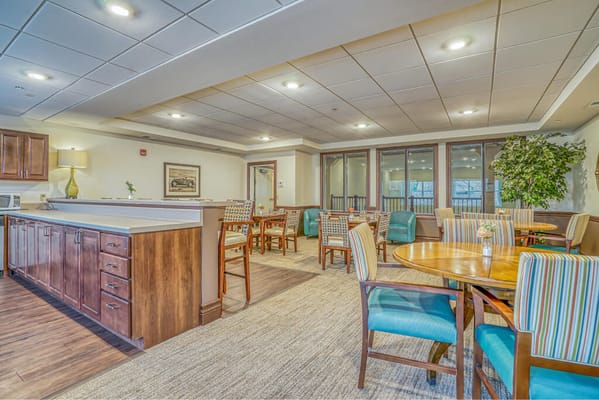 Bright common area with dining tables and chairs