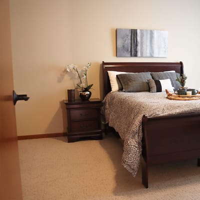 Cozy private bedroom with a neatly made bed and decor