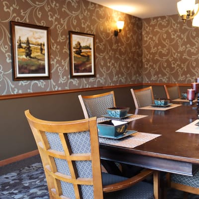 Dining room with a beautifully set table and artwork on the wall