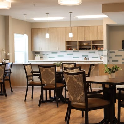 Bright dining area with chairs and a kitchen