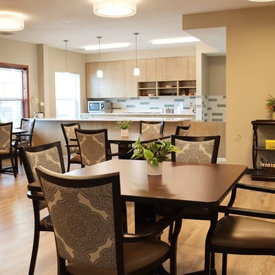 Bright common area with dining tables and kitchenette